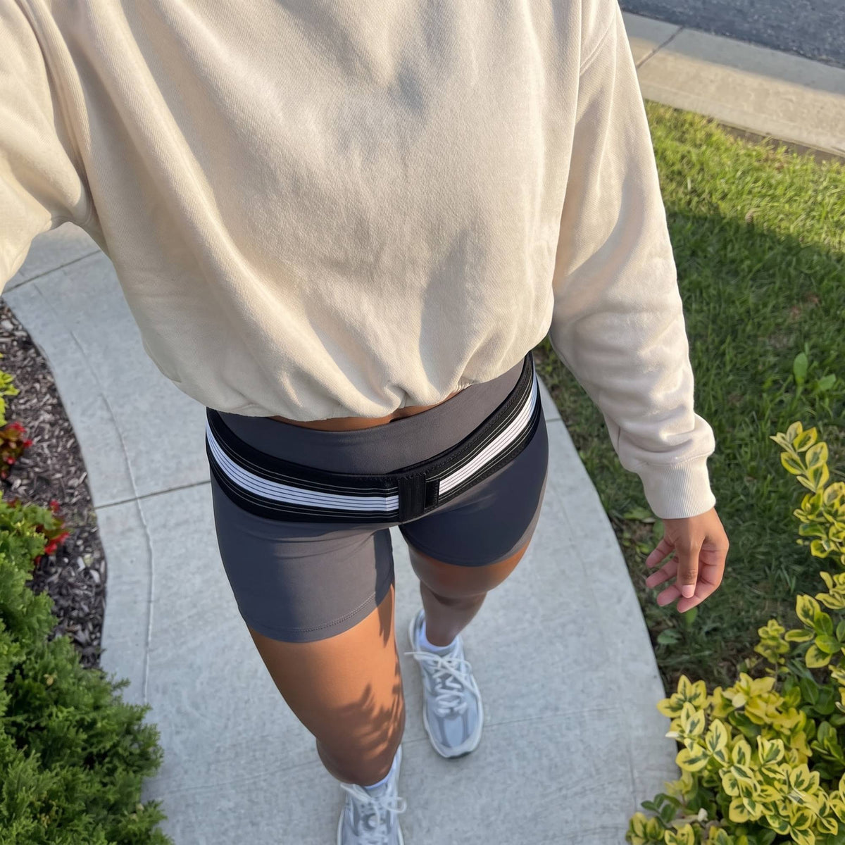 Top-down view of the support belt worn low across the hip bones over bike shorts