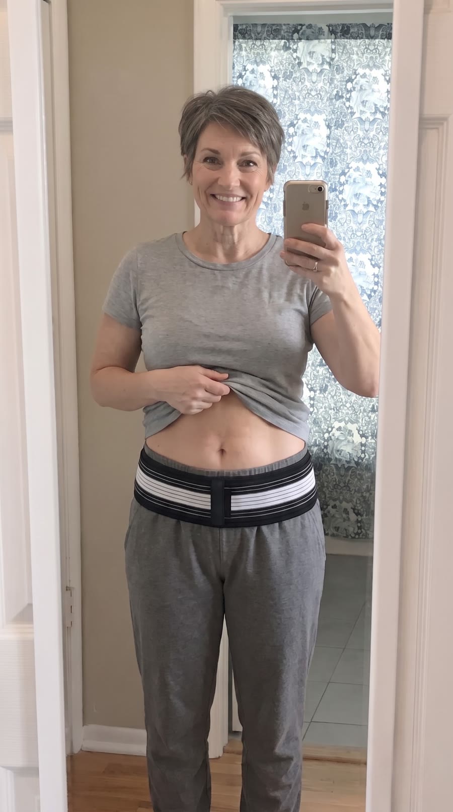 Customer showing the support belt sitting low across the hip bones over joggers